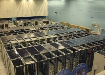 Server hall with racks of networking equipment in a data centre