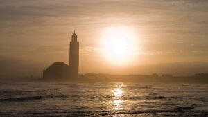 Hassan II Mosque silhouetted against the Atlantic at sunset, Casablanca