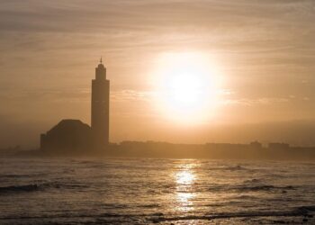 Hassan II Mosque silhouetted against the Atlantic at sunset, Casablanca